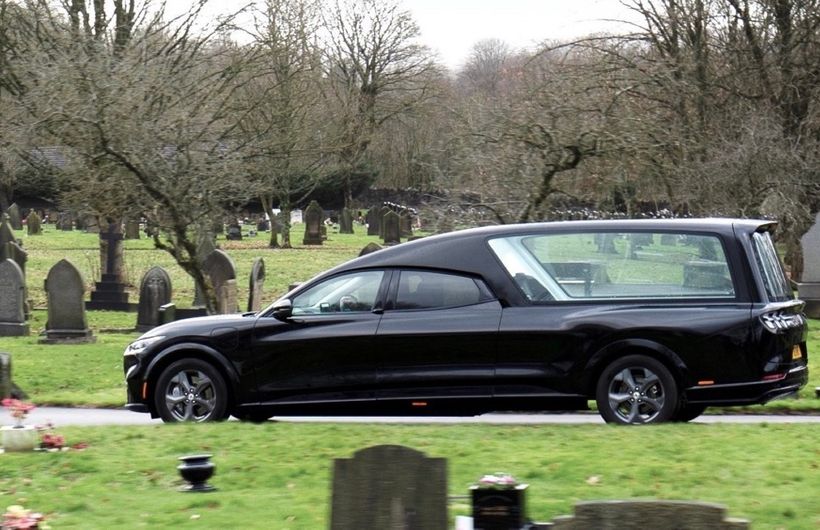 Ford Mach e hearse side on shot, in graveyard